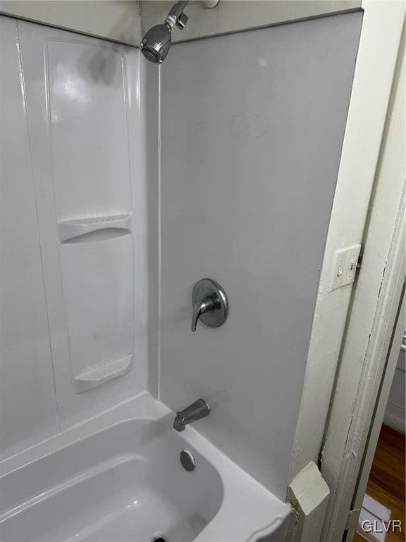 bathroom featuring bathtub / shower combination and hardwood / wood-style flooring