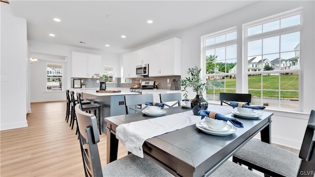 dining space with light hardwood / wood-style floors