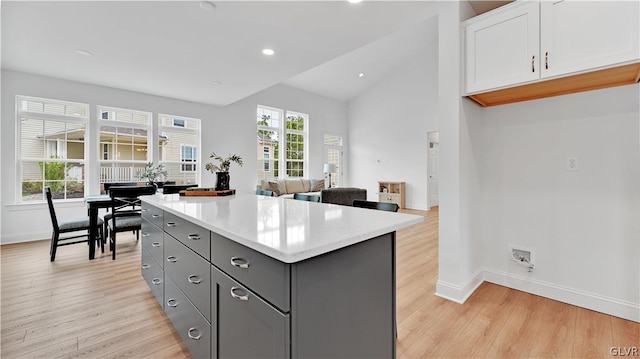 kitchen featuring light hardwood / wood-style flooring, a wealth of natural light, and gray cabinetry