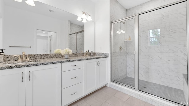 bathroom featuring dual vanity, tile patterned floors, and an enclosed shower