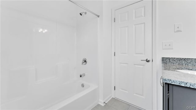 bathroom with vanity, tile patterned flooring, and washtub / shower combination