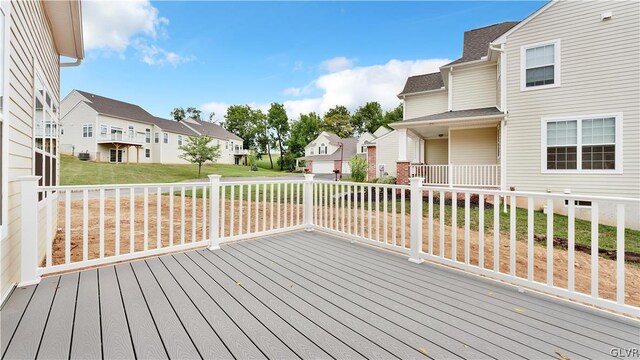 wooden terrace featuring a lawn