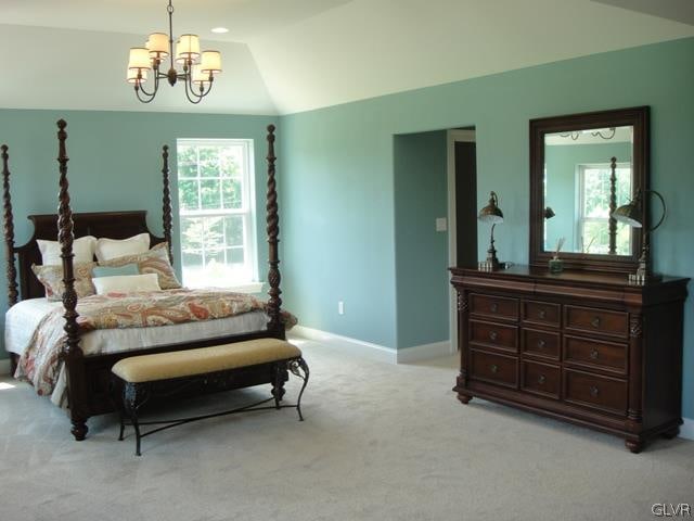 carpeted bedroom featuring lofted ceiling and a chandelier