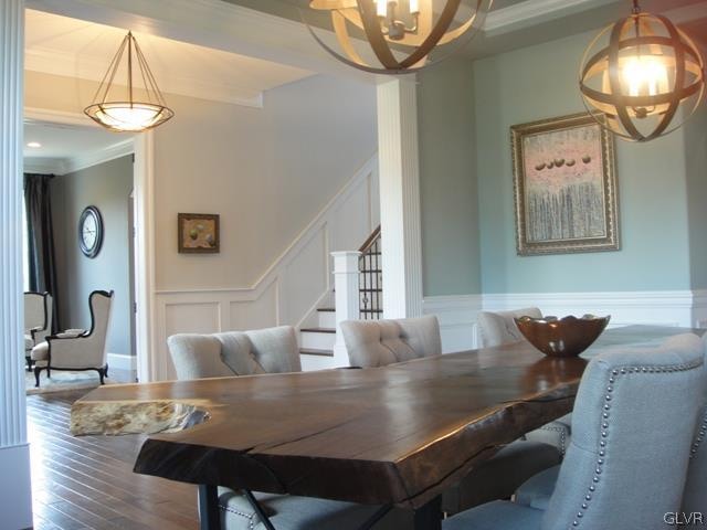 dining room featuring crown molding, hardwood / wood-style floors, and a chandelier