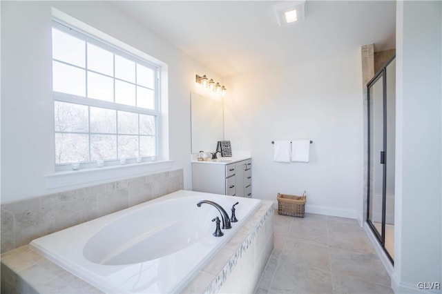 bathroom featuring plus walk in shower, tile patterned floors, and vanity