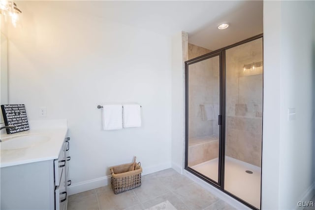 bathroom with tile patterned floors, walk in shower, and vanity