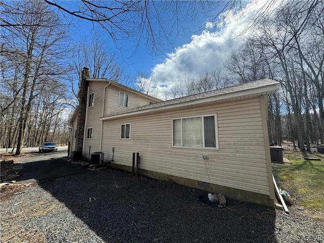 view of side of home featuring central AC