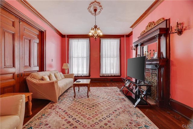 sitting room featuring ornamental molding, an inviting chandelier, and dark wood-type flooring