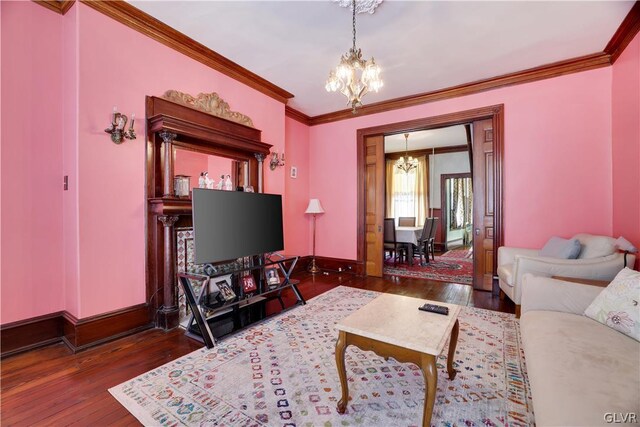 living room with a notable chandelier, dark wood-type flooring, and crown molding