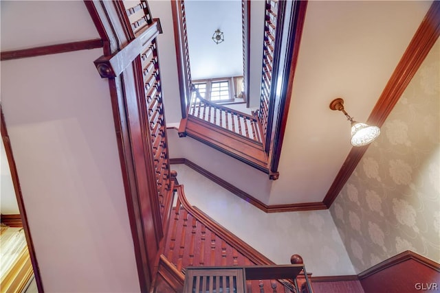 stairway featuring crown molding