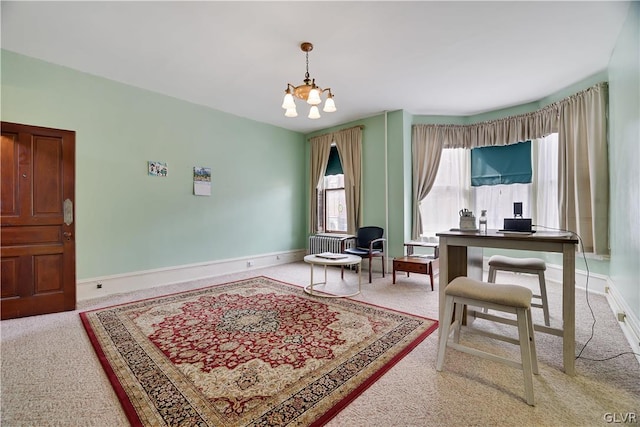 sitting room with carpet floors, an inviting chandelier, and baseboards