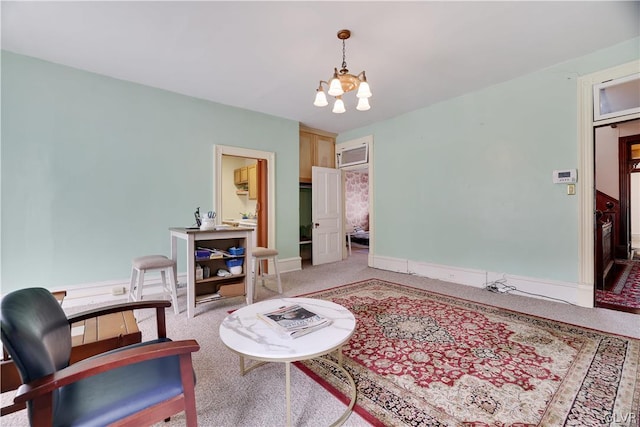 sitting room with a chandelier, light carpet, and baseboards