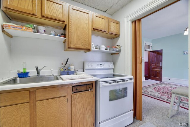 kitchen featuring light brown cabinetry, sink, a drop ceiling, electric range, and light carpet