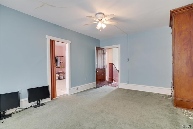 unfurnished bedroom with ceiling fan, carpet, and baseboards