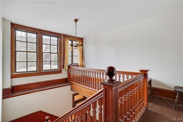 stairs with wood finished floors and baseboards