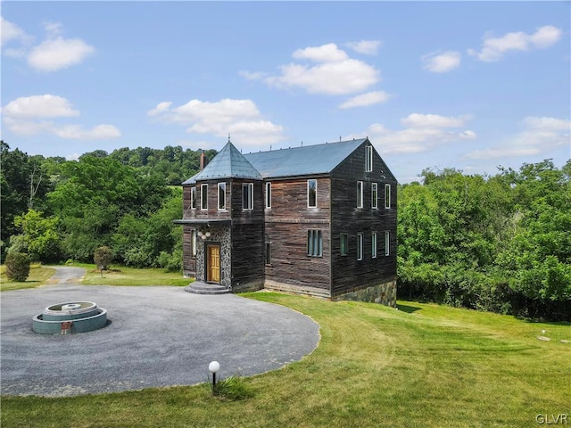 back of property featuring a lawn