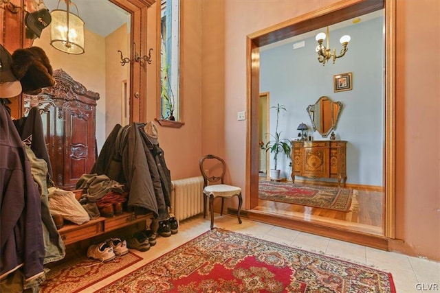 sitting room featuring light tile patterned flooring, radiator, and a notable chandelier