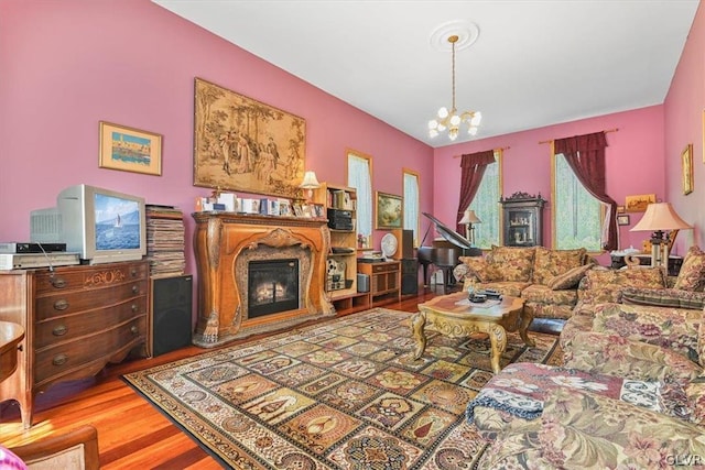 living room with hardwood / wood-style floors and an inviting chandelier