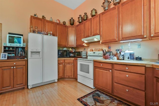 kitchen featuring light hardwood / wood-style flooring and white appliances