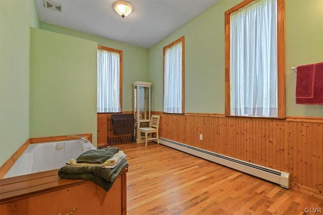 interior space featuring light hardwood / wood-style floors and a baseboard radiator