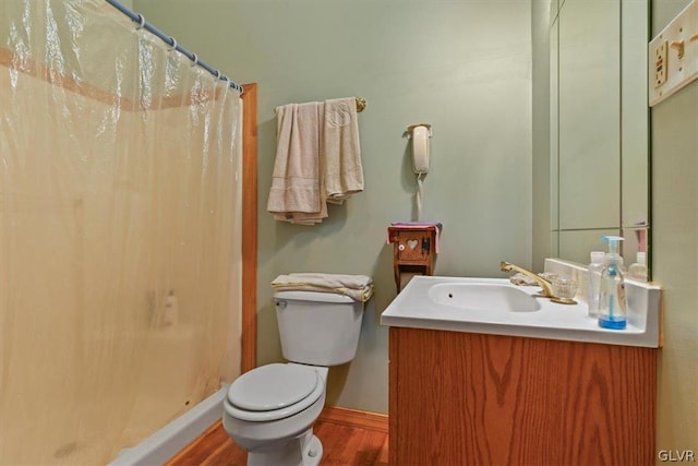 bathroom featuring vanity, toilet, walk in shower, and hardwood / wood-style floors