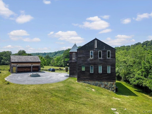 view of side of home with a garage and a lawn