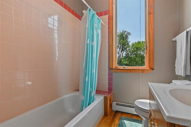 full bathroom with vanity, shower / bathtub combination with curtain, hardwood / wood-style floors, a baseboard heating unit, and toilet