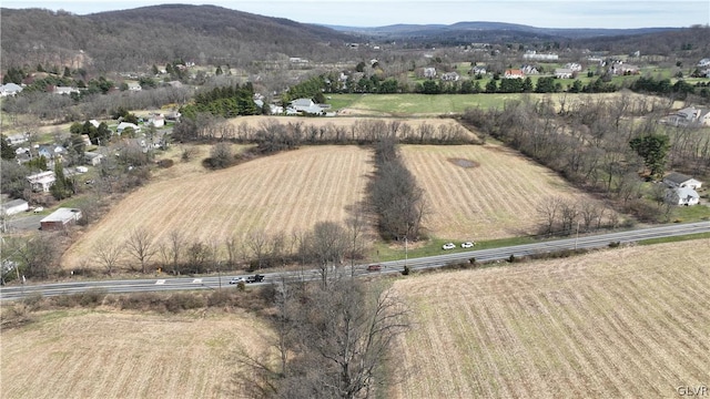 drone / aerial view featuring a rural view and a mountain view