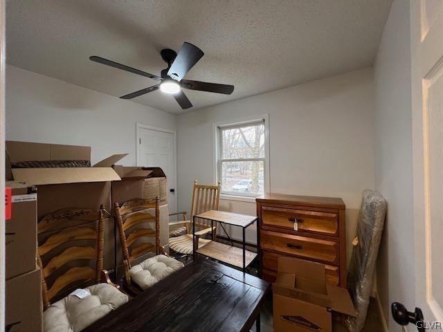 bedroom with a textured ceiling and ceiling fan