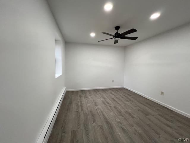 spare room featuring ceiling fan, hardwood / wood-style floors, and a baseboard radiator