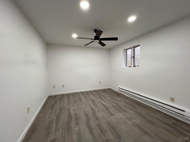 basement with ceiling fan, wood-type flooring, and baseboard heating