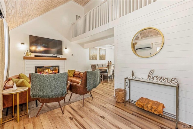 living room featuring light hardwood / wood-style floors and a towering ceiling