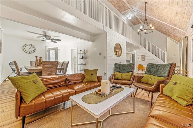 living room featuring wood ceiling, light wood-type flooring, ceiling fan with notable chandelier, and vaulted ceiling