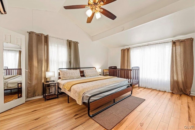 bedroom with vaulted ceiling, light hardwood / wood-style flooring, and ceiling fan