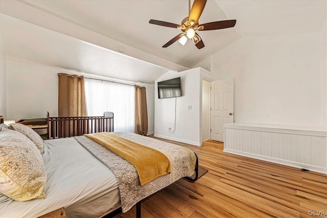 bedroom with light hardwood / wood-style floors, ceiling fan, and vaulted ceiling