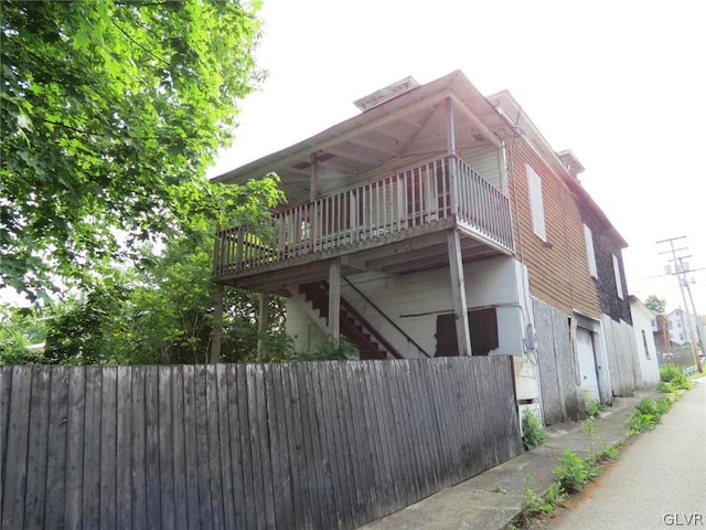 view of home's exterior featuring a garage and a deck