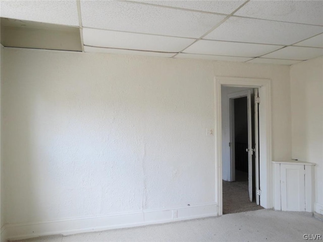 spare room with a drop ceiling and carpet floors