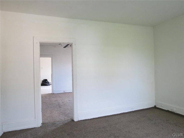 empty room featuring dark colored carpet