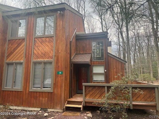 back of house featuring a wooden deck