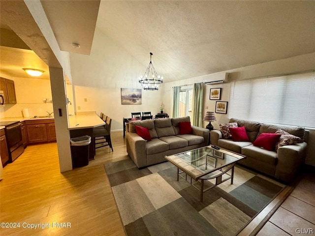 living room featuring light wood-type flooring, a textured ceiling, vaulted ceiling, a chandelier, and sink