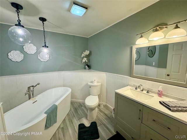 bathroom featuring toilet, a bathtub, and vanity