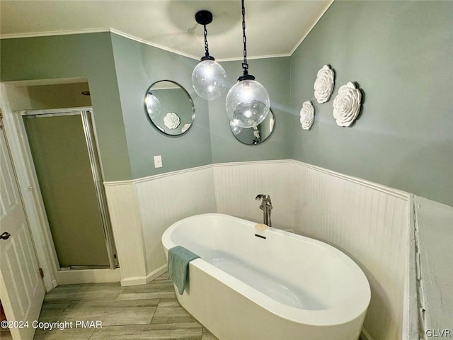 bathroom with ornamental molding, hardwood / wood-style flooring, and plus walk in shower