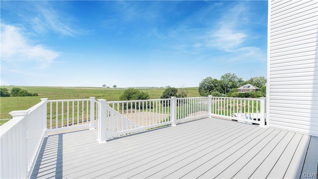 wooden deck featuring a yard and a rural view