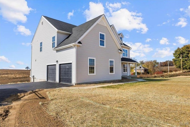 view of side of home with a garage and a yard