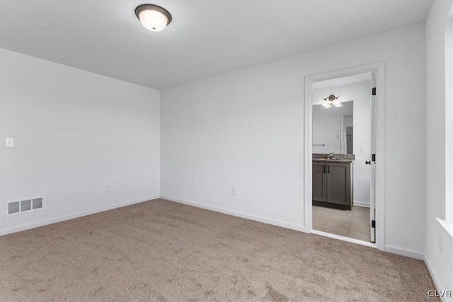 carpeted empty room with sink