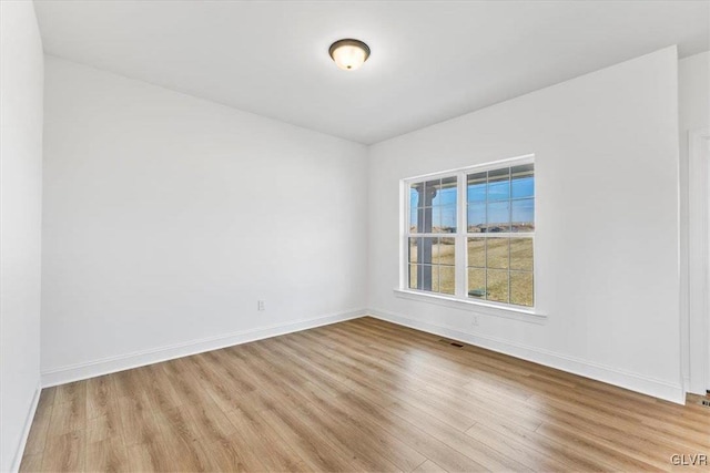 spare room featuring light hardwood / wood-style floors