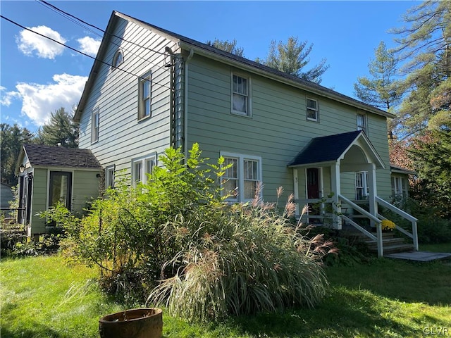 rear view of house with a lawn