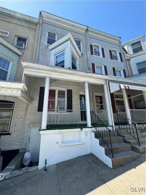 townhome / multi-family property with covered porch