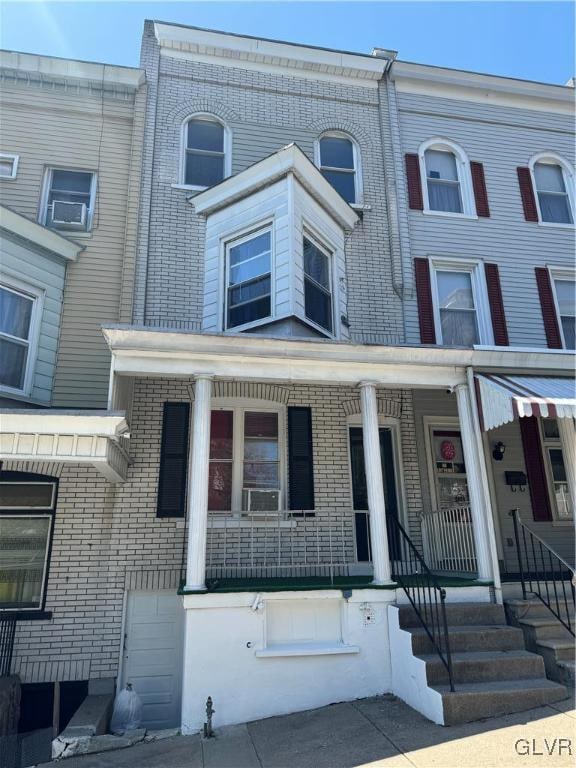 townhome / multi-family property featuring covered porch