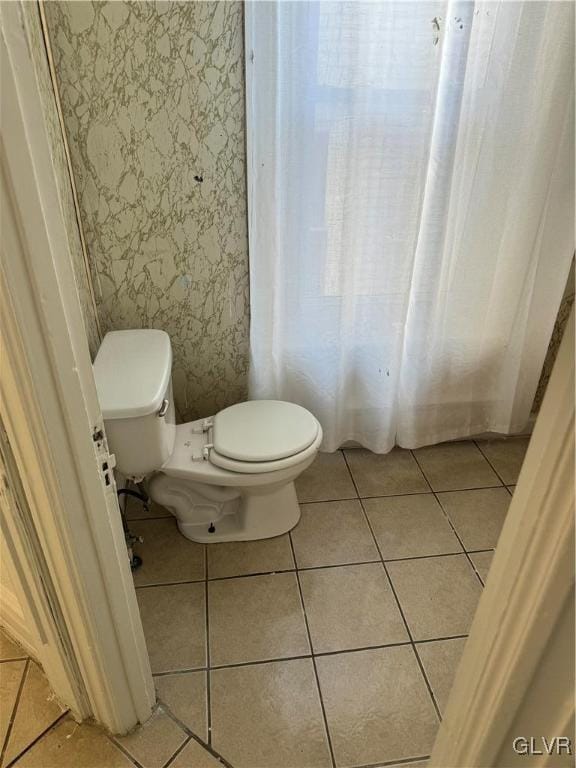 bathroom with tile patterned flooring and toilet